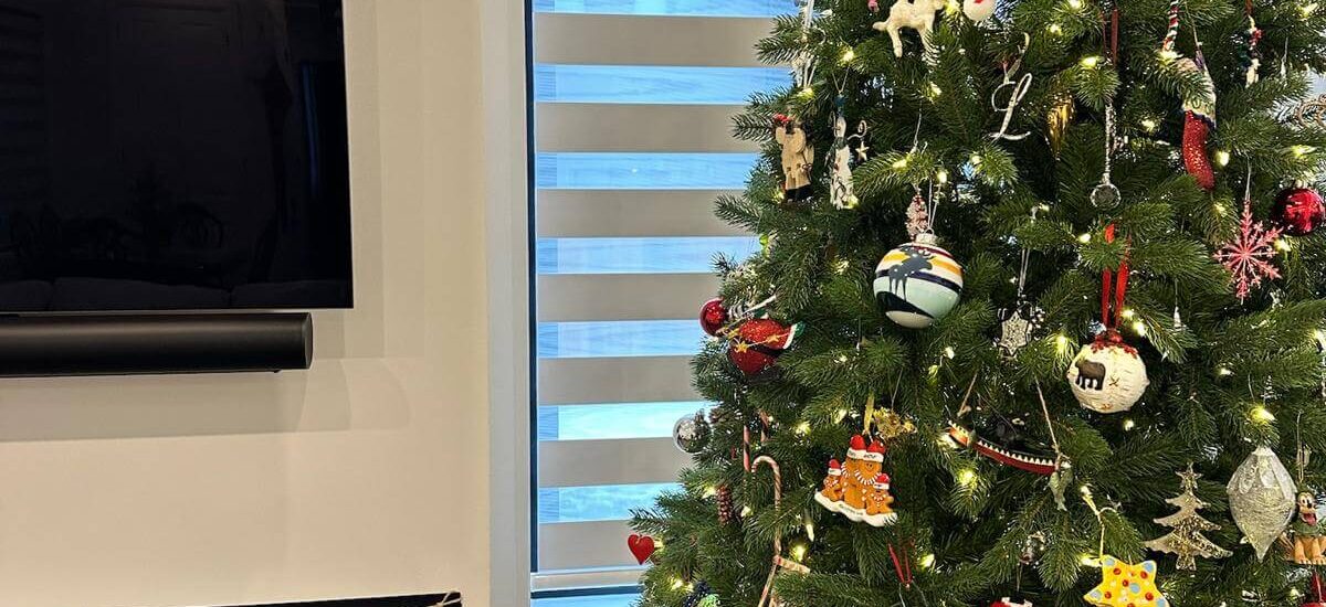 Zebra blinds from ava shutters behind a Christmas tree